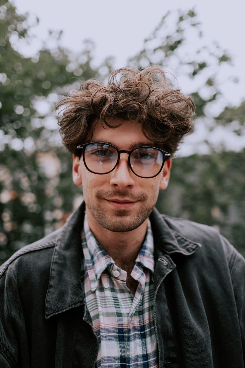 Portrait of Dr. Marcus Delgado, DO, smiling and wearing glasses