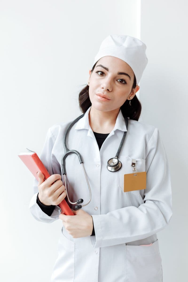 Portrait of Hannah Whitfield, CPNP-PC, in a white medical coat